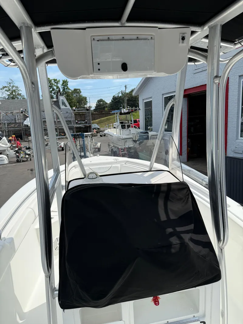 Slide: The Image of 2014 Sea Hunt Ultra 211 boat interior with T-top and console cover. - 8