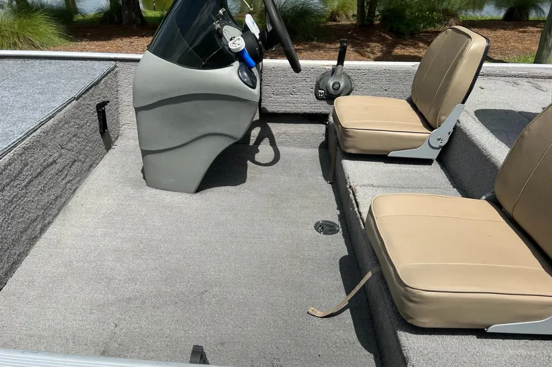 Slide: The Image of 2012 Tracker Pro165 boat interior with beige seats and steering console. - 3