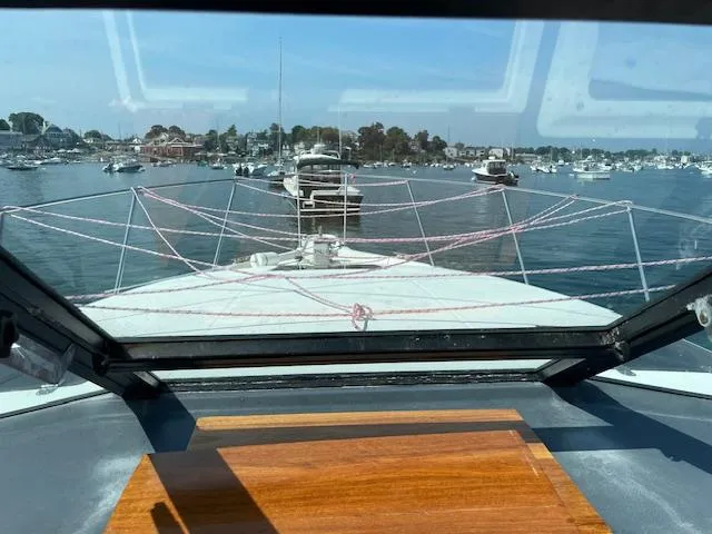Slide: The Image of 1990 Tiara Yachts 31 Open, view from cabin, overlooking marina with boats. - 12