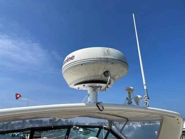 Slide: The Image of Radar equipment on a 1990 Tiara Yachts 31 Open against a clear blue sky. - 13