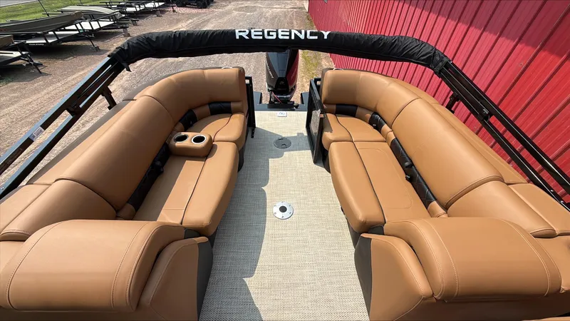 Slide: The Image of 2025 Regency 230 LE3 pontoon boat with tan leather seating and cup holders. - 5