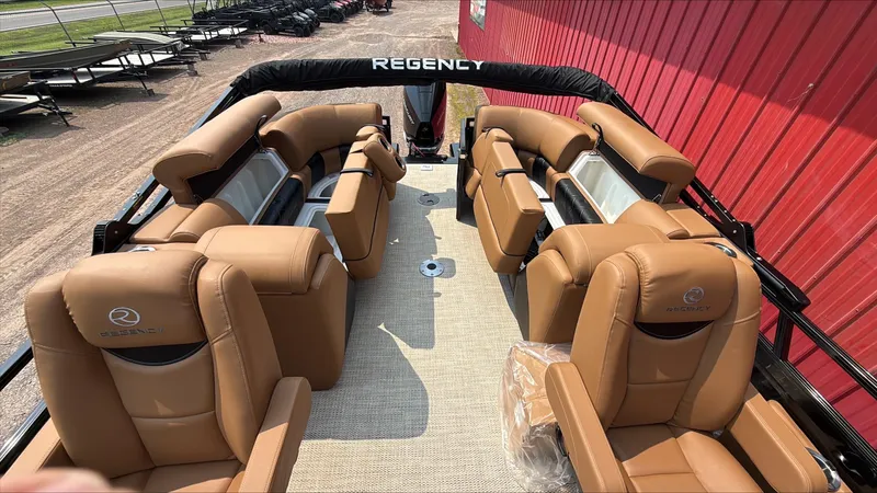 Slide: The Image of 2025 Regency 230 LE3 boat interior with tan leather seating and spacious layout. - 7