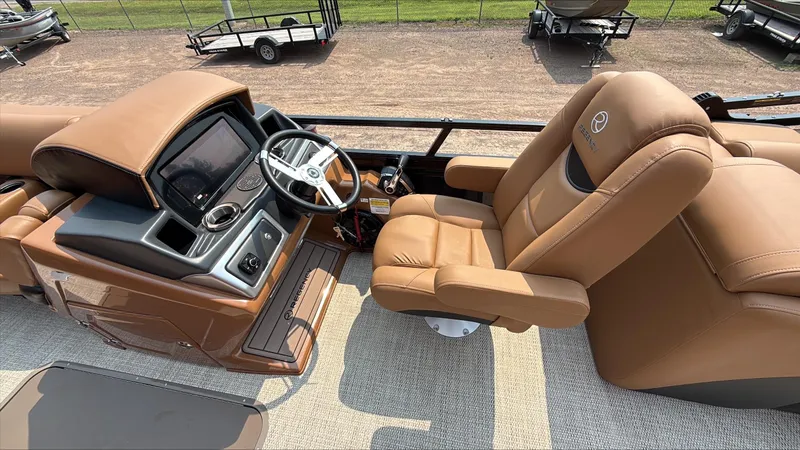 Slide: The Image of Luxurious helm of 2025 Regency 230 LE3 boat with tan leather seating. - 9