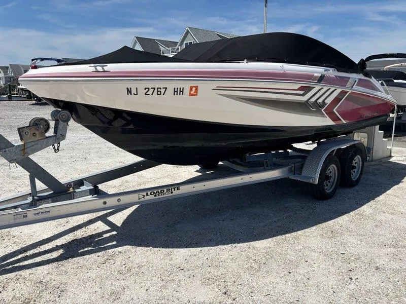 Slide: The Image of 2016 Regal 2000 ESX Bowrider on trailer, parked outdoors, covered and ready for transport. - 1