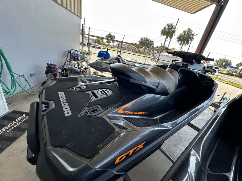 Slide: The Image of 2023 Sea-Doo GTX 230 jet ski in a garage setting. - 2
