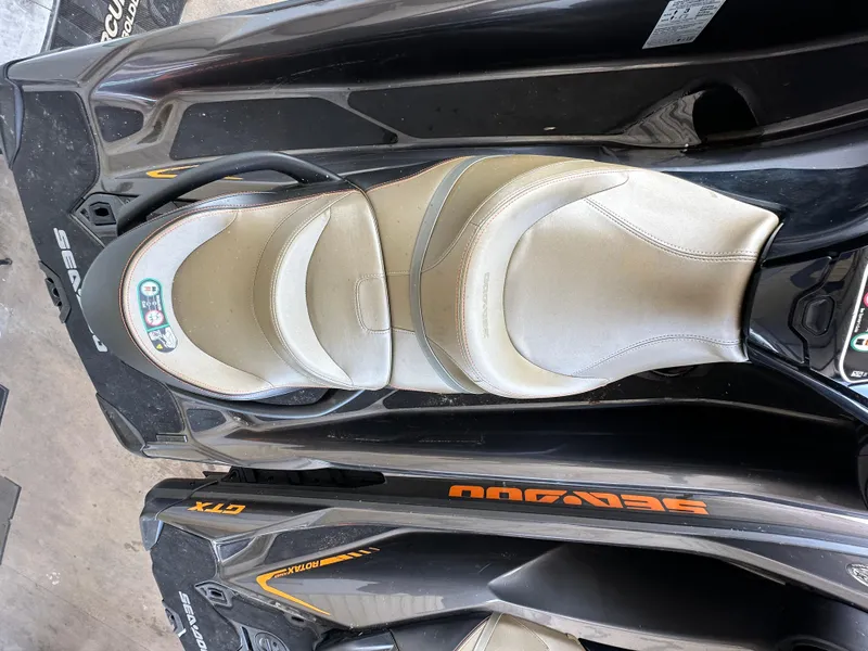 Slide: The Image of 2023 Sea-Doo GTX 230 jet ski with beige seat and sleek black design. - 3