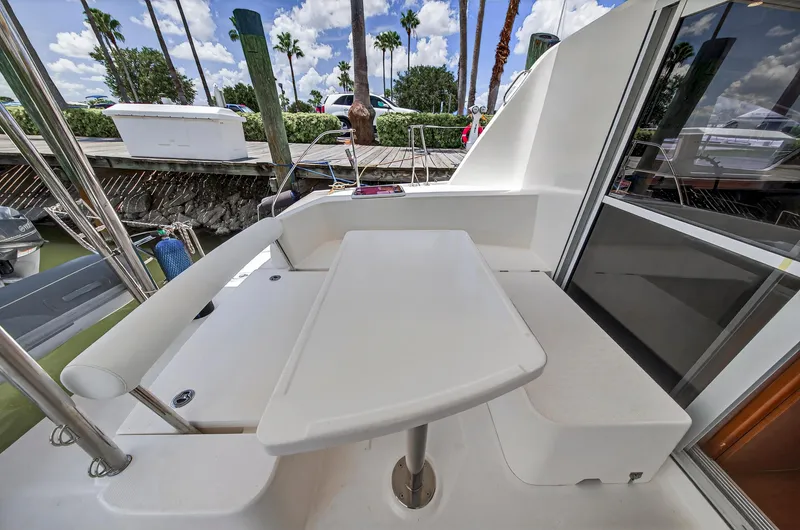 Slide: The Image of Outdoor seating area on a 2011 Leopard 38 catamaran, featuring a sleek white table. - 16