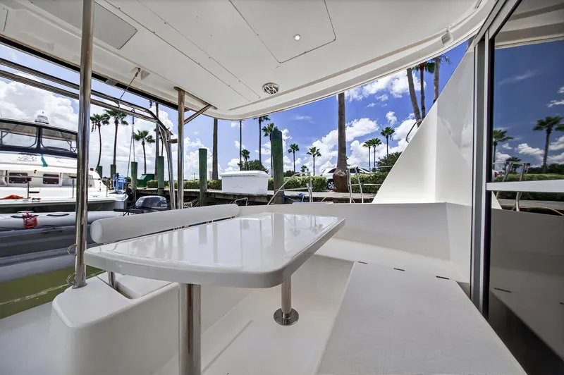 Slide: The Image of Leopard 38 yacht deck with table, palm trees, and marina view, 2011 model. - 17