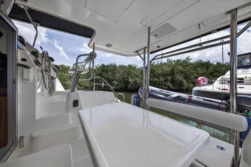 Slide: The Image of 2011 Leopard 38 yacht interior with steering wheel, table, and outdoor view. - 18