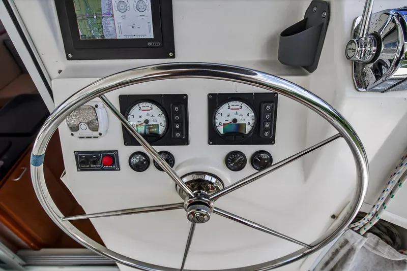 Slide: The Image of Steering wheel and gauges on a 2011 Leopard 38 yacht control panel. - 26