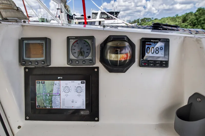 Slide: The Image of Navigation instruments on a 2011 Leopard 38 catamaran, featuring compass and digital displays. - 27