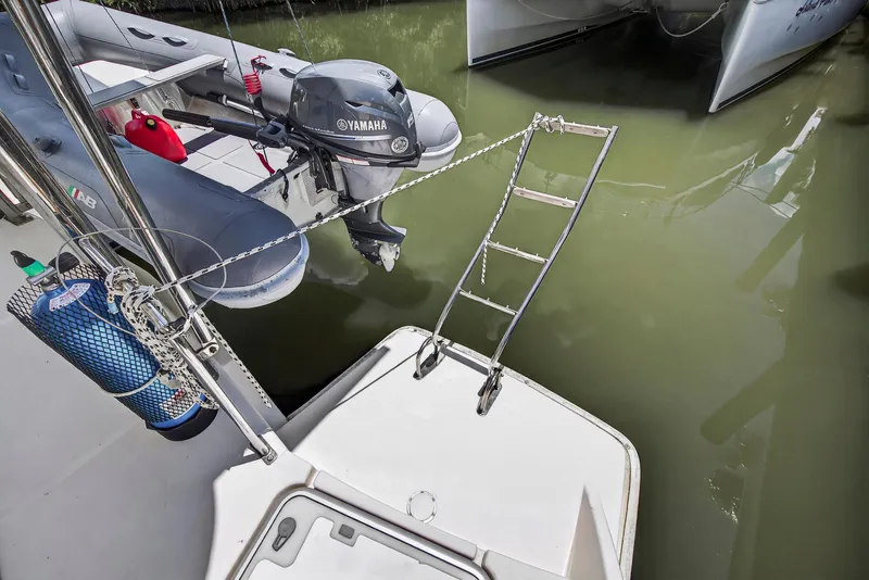 Slide: The Image of Leopard 38 catamaran with Yamaha motor and boarding ladder, docked in calm waters. - 33