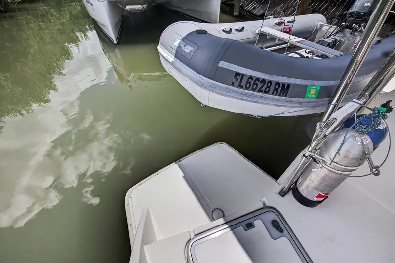 Slide: The Image of Inflatable boat alongside Leopard 38 catamaran, 2011 model, docked on calm water. - 34