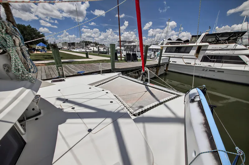 Slide: The Image of 2011 Leopard 38 catamaran docked at marina, sunny day, clear sky, boats in background. - 40