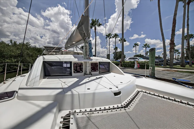 Slide: The Image of 2011 Leopard 38 catamaran docked under a sunny sky with palm trees. - 44