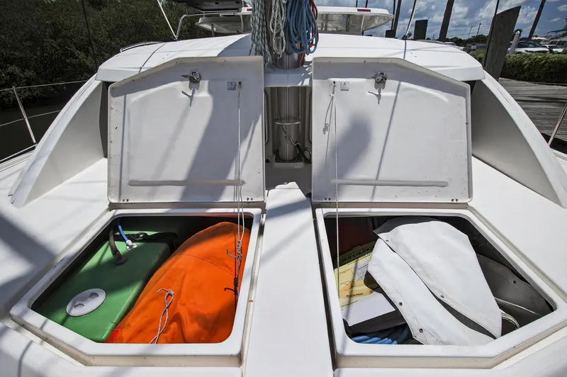 Slide: The Image of Open storage compartments on a 2011 Leopard 38 catamaran, revealing equipment and supplies. - 48