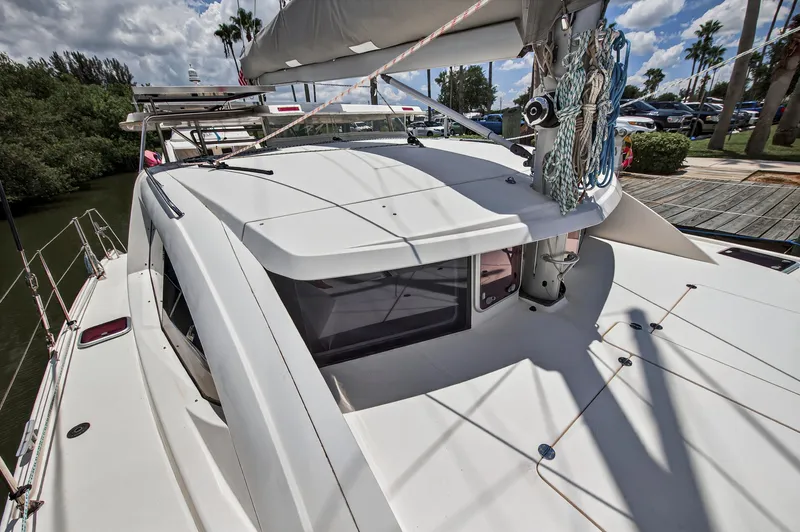 Slide: The Image of 2011 Leopard 38 catamaran docked, showcasing sleek design and rigging under a sunny sky. - 53