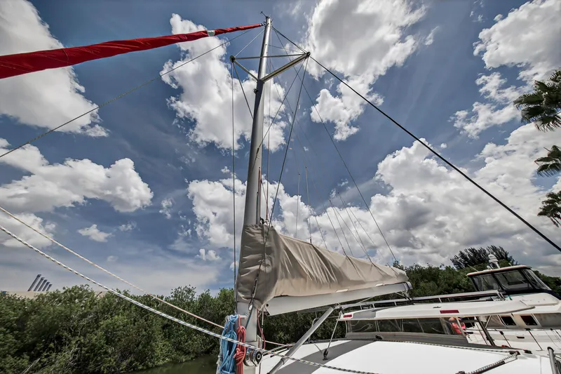 Slide: The Image of Sailboat Leopard 38, 2011 model, with mast and sail against a cloudy sky. - 54