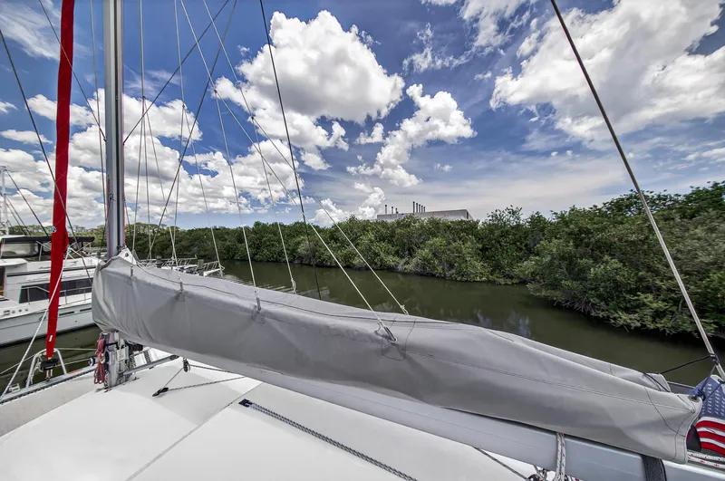 Slide: The Image of Sailboat Leopard 38, 2011 model, docked near lush greenery under a vibrant sky. - 56