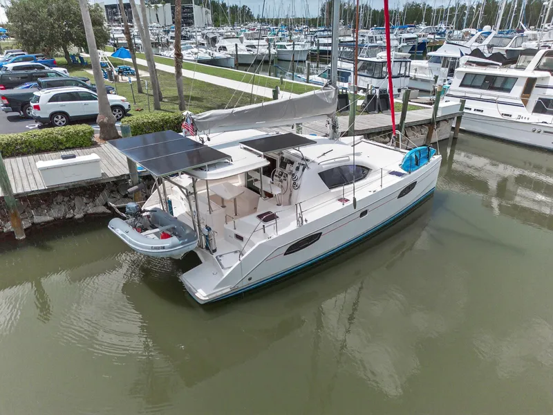 Slide: The Image of 2011 Leopard 38 catamaran docked at marina with solar panels and dinghy. - 6