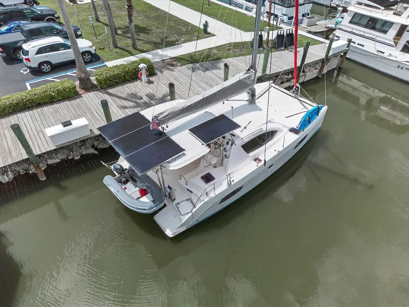 Slide: The Image of Aerial view of a 2011 Leopard 38 catamaran docked, featuring solar panels and a dinghy. - 7