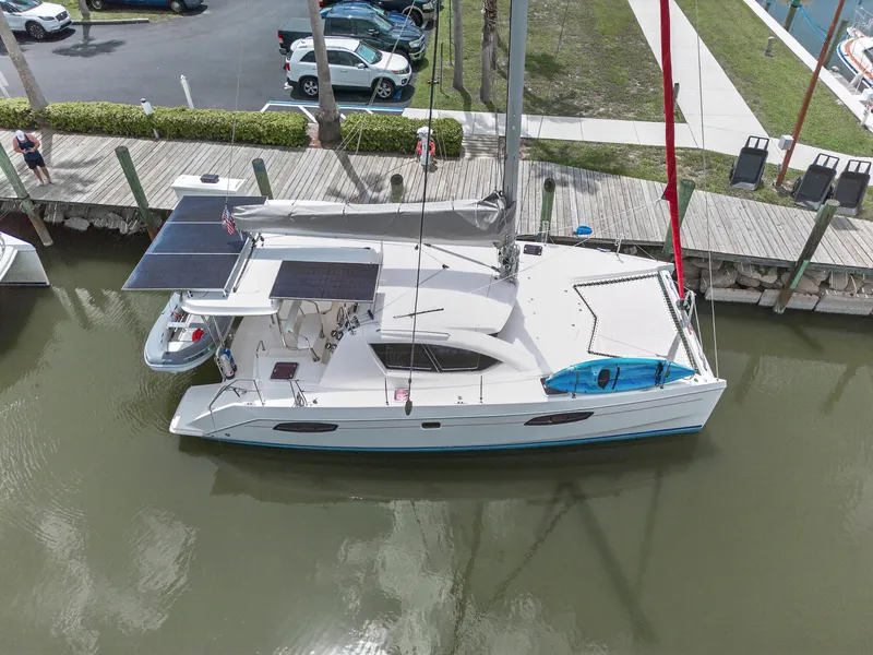 Slide: The Image of Leopard 38 catamaran docked, featuring solar panels and a kayak, viewed from above. - 8