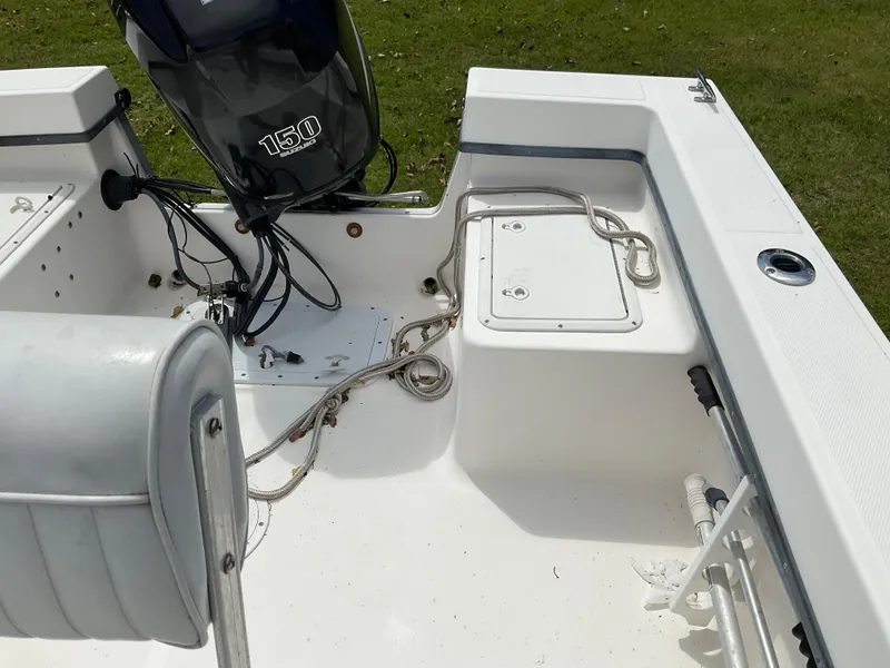 Slide: The Image of 2007 May-Craft 2000CC boat interior with 150 horsepower engine, white deck, and seating. - 11