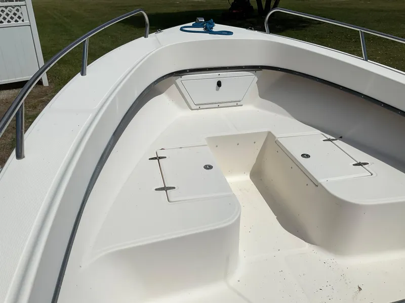 Slide: The Image of 2007 May-Craft 2000CC boat interior with storage compartments and railing. - 15