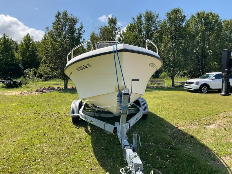 Slide: The Image of 2007 May-Craft 2000CC boat on trailer, parked on grassy area with trees. - 2