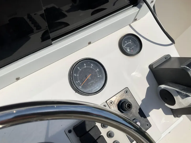 Slide: The Image of Control panel of a 2007 May-Craft 2000CC boat with gauges and steering wheel. - 20