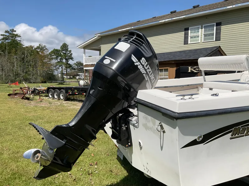 Slide: The Image of 2007 May-Craft 2000CC boat with Suzuki outboard motor on grassy yard. - 4