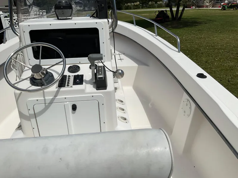 Slide: The Image of 2007 May-Craft 2000CC boat interior with steering wheel and control panel. - 9