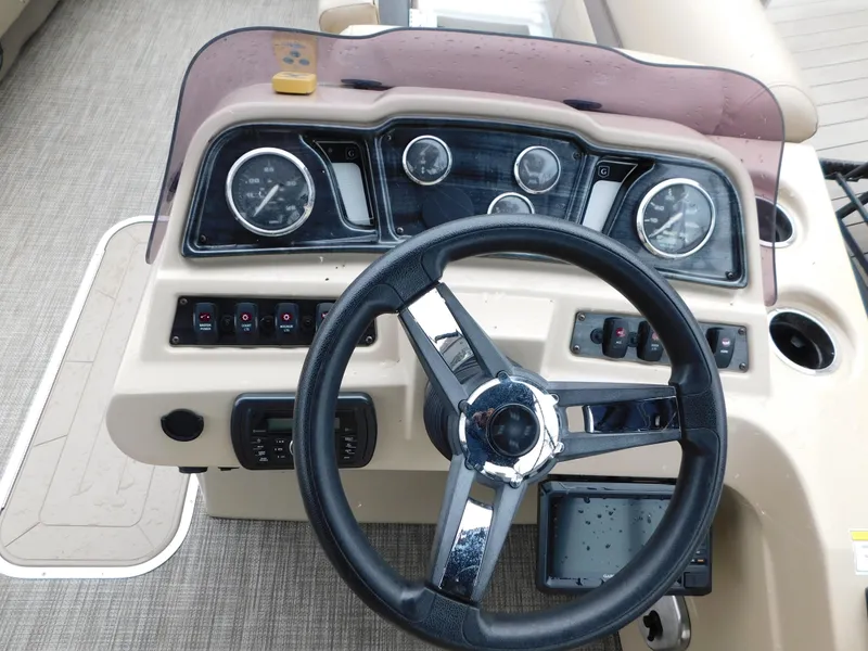 Slide: The Image of 2019 Godfrey SWEETWATER 2186 SB boat dashboard with steering wheel and instrument panel. - 11