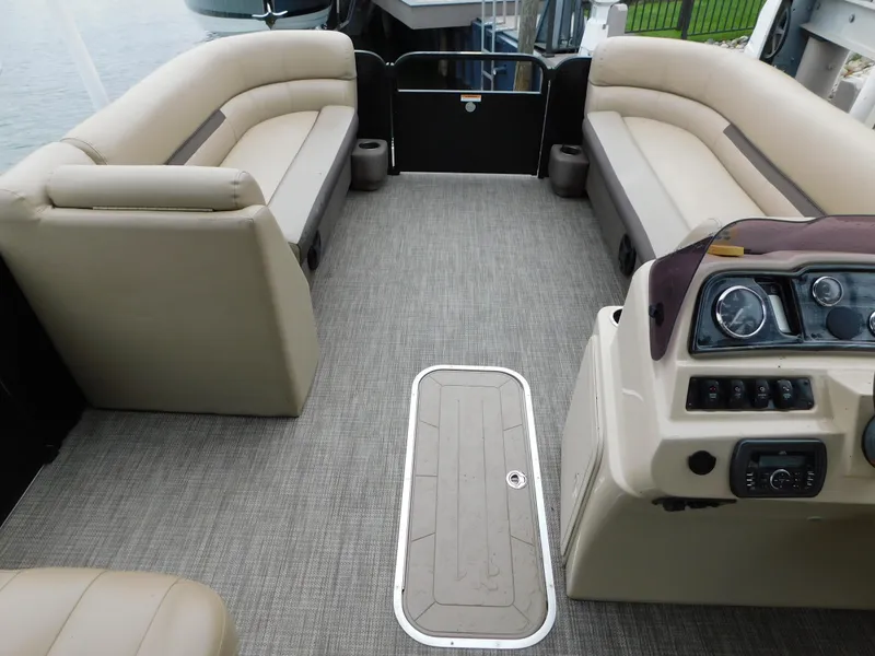 Slide: The Image of Interior of a 2019 Godfrey SWEETWATER 2186 SB pontoon boat with beige seating and control panel. - 14