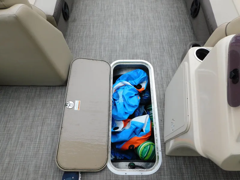 Slide: The Image of Storage compartment on 2019 Godfrey SWEETWATER 2186 SB boat, containing colorful inflatables. - 15