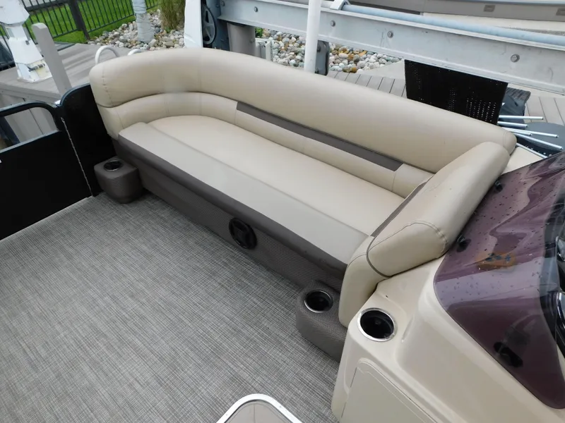 Slide: The Image of 2019 Godfrey SWEETWATER 2186 SB boat interior with beige seating and cup holders. - 18