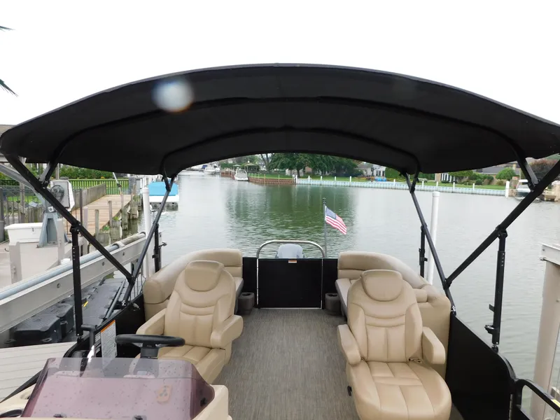 Slide: The Image of 2019 Godfrey SWEETWATER 2186 SB pontoon boat with canopy on a calm river. - 24