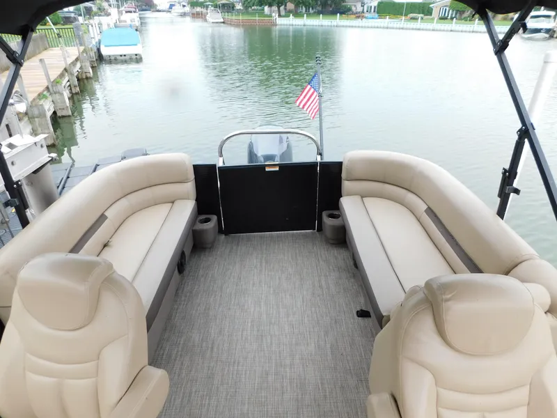 Slide: The Image of 2019 Godfrey SWEETWATER 2186 SB pontoon boat interior with beige seating and lake view. - 27