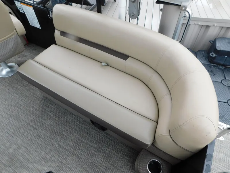 Slide: The Image of Beige seating on 2019 Godfrey SWEETWATER 2186 SB pontoon boat, featuring cup holder and carpeted floor. - 29