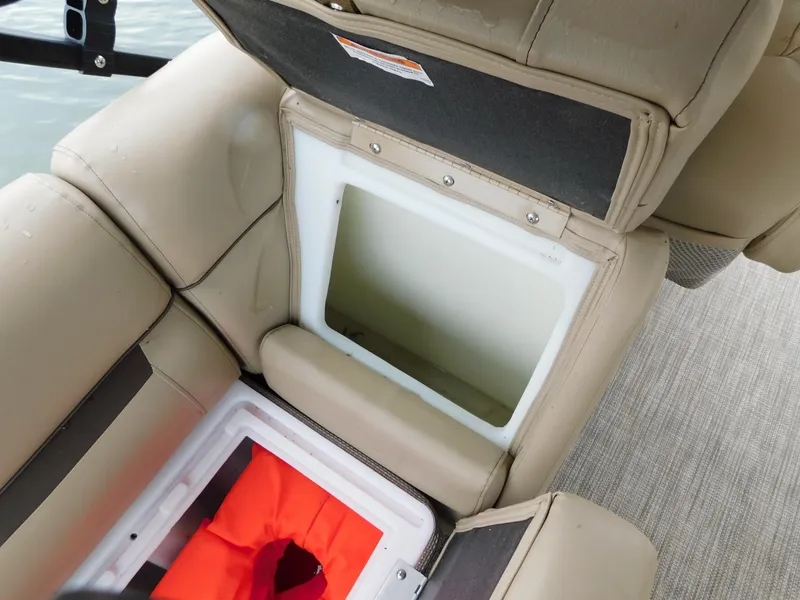 Slide: The Image of Open storage compartment on 2019 Godfrey SWEETWATER 2186 SB boat with life jacket inside. - 35