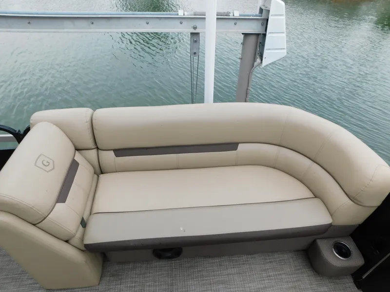 Slide: The Image of 2019 Godfrey SWEETWATER 2186 SB boat with beige seating, docked on calm water. - 38