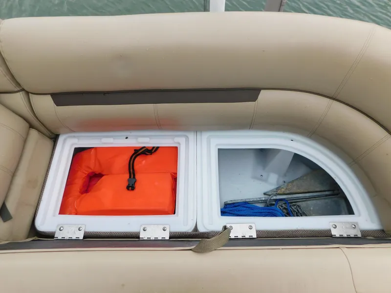 Slide: The Image of 2019 Godfrey SWEETWATER 2186 SB boat storage compartments with life jacket and anchor. - 39