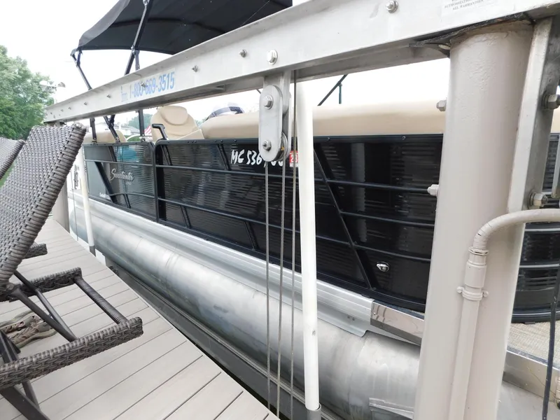 Slide: The Image of 2019 Godfrey SWEETWATER 2186 SB pontoon boat docked beside wicker chairs. - 5
