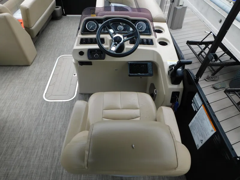 Slide: The Image of 2019 Godfrey SWEETWATER 2186 SB boat helm with beige seating and control panel. - 8