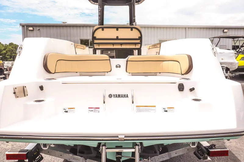 Slide: The Image of 2025 Yamaha Boats 255 FSH Sport E, rear view with seating and logo. - 10
