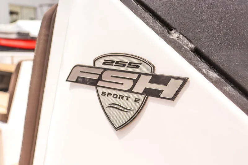 Slide: The Image of 2025 Yamaha Boats 255 FSH Sport E emblem on white surface. - 12