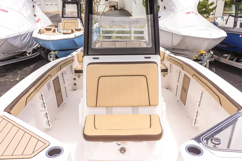 Slide: The Image of 2025 Yamaha Boats 255 FSH Sport E interior with tan seating and fishing features. - 14