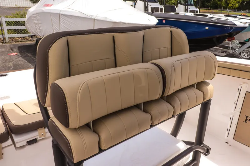 Slide: The Image of 2025 Yamaha Boats 255 FSH Sport E seating, featuring tan upholstery and sleek design. - 17