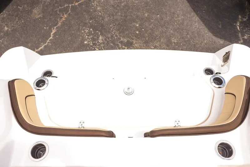 Slide: The Image of 2025 Yamaha Boats 255 FSH Sport E, white deck with tan seating and cup holders. - 18