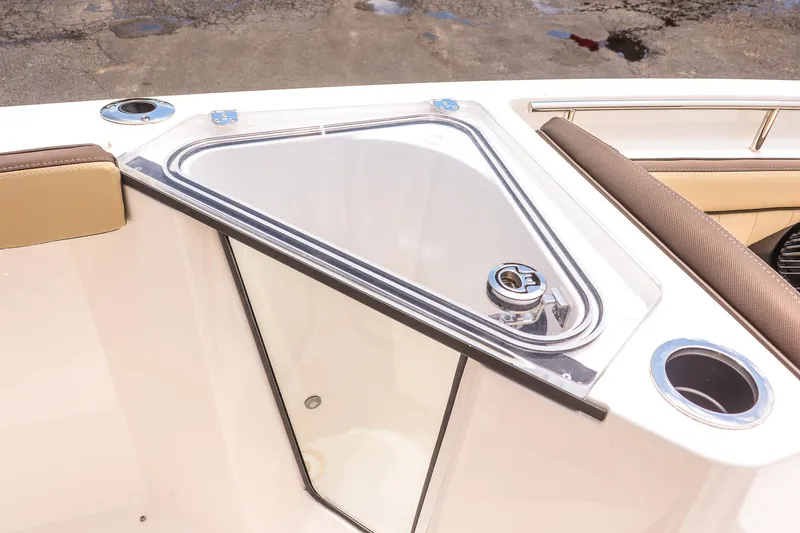 Slide: The Image of 2025 Yamaha Boats 255 FSH Sport E bow seating with storage compartment and cup holders. - 19